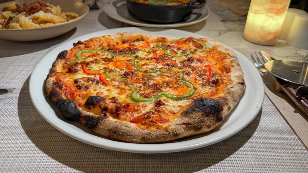 Flour Mijas | Krista the Explorer Handmade pizza topped with peppers and ground beef.