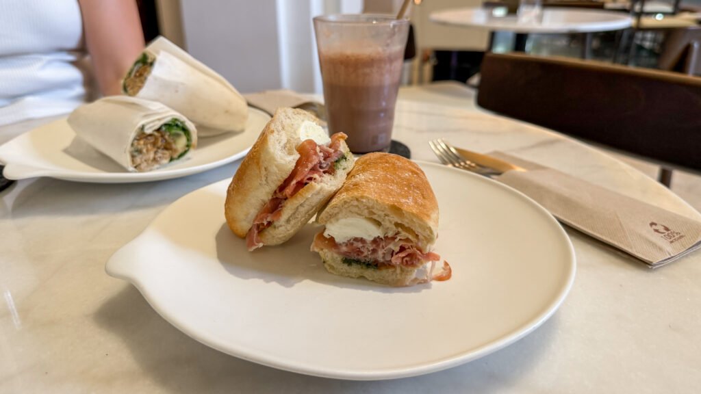 Bloom Malaga | Krista the Explorer Mozzarella and pesto sandwich on ciabatta bread in cafe.
