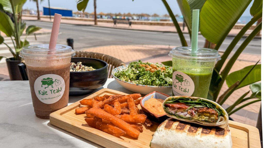 Selection of healthy food on table next to beach.