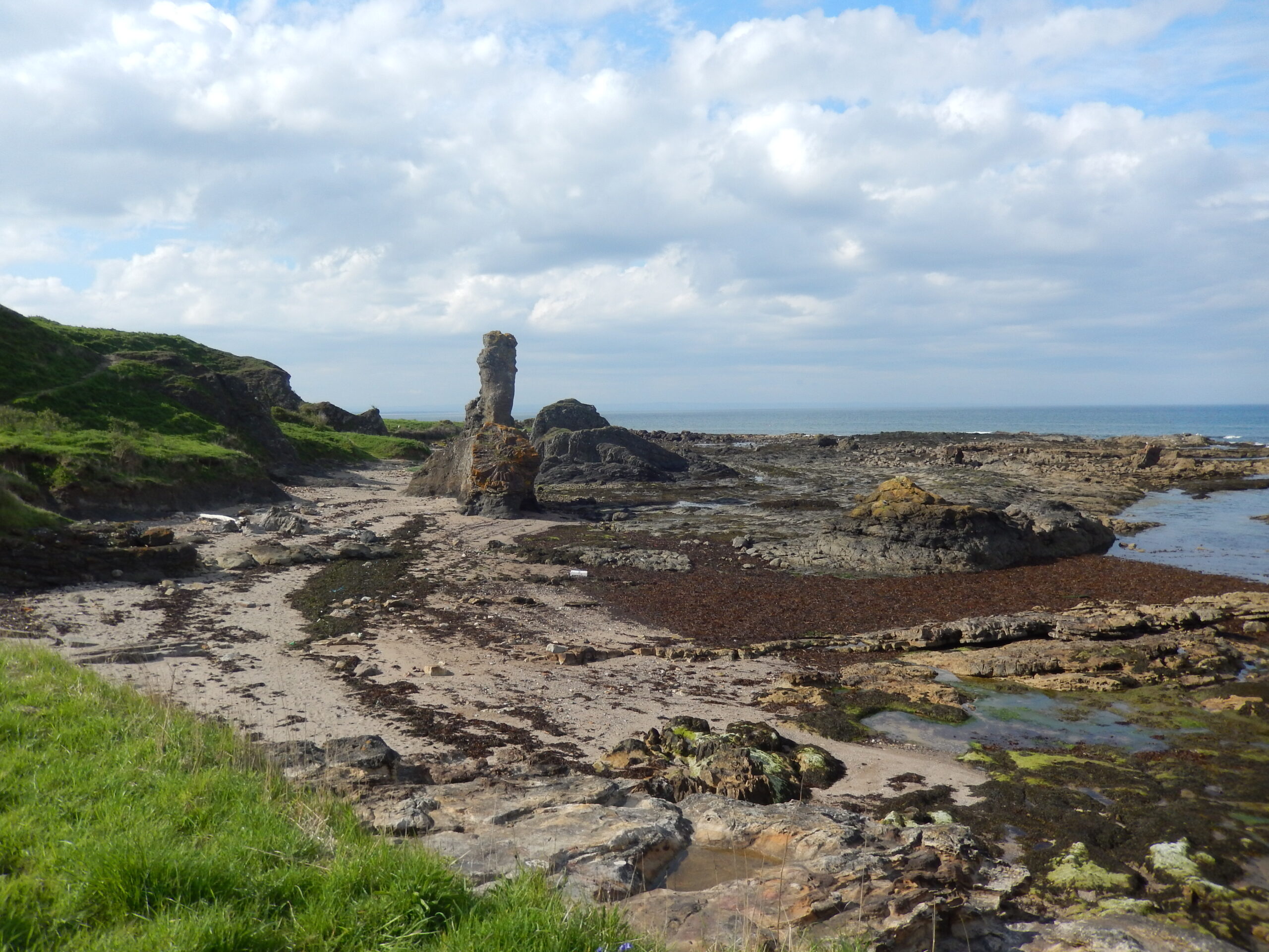 Tall rock formation along coastal path in Fife.