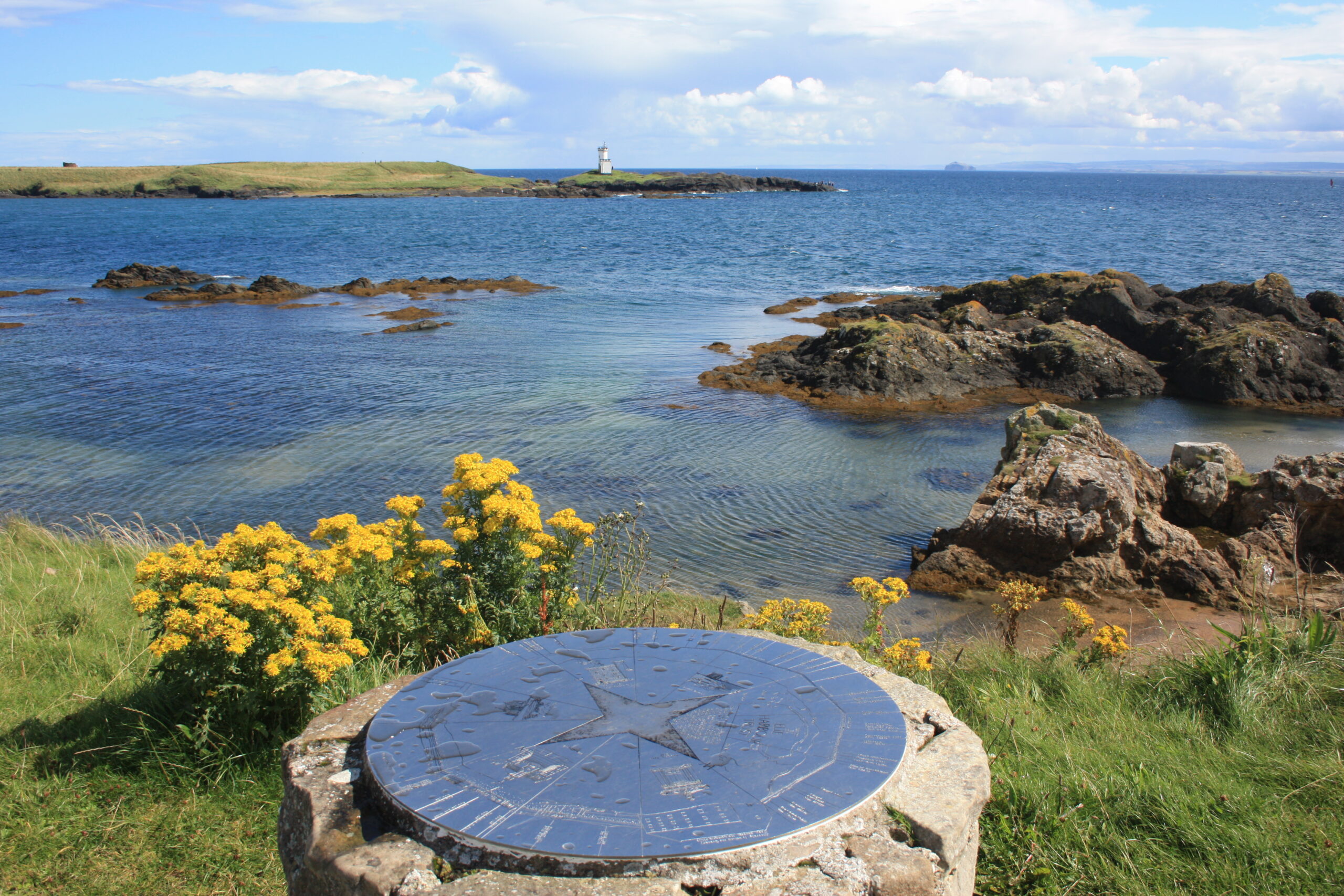 Lighthouse harbour along coast in Fife