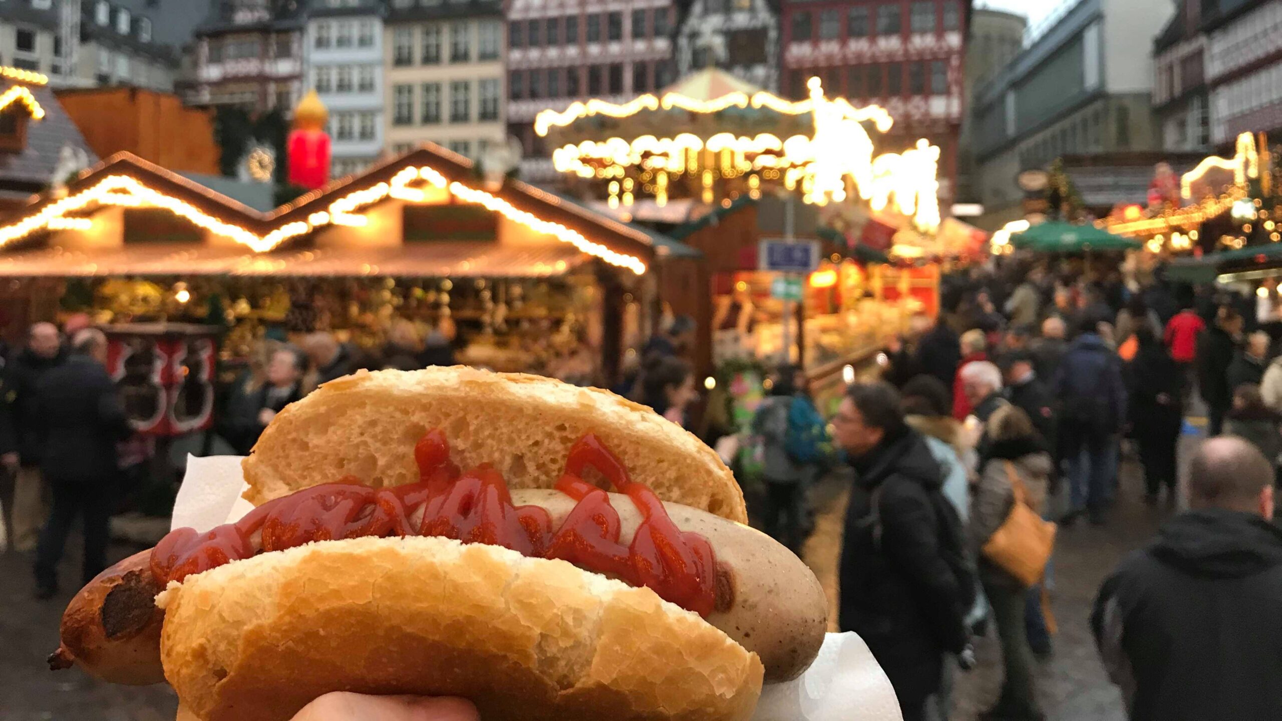 Bratwurst in bun at Christmas market.