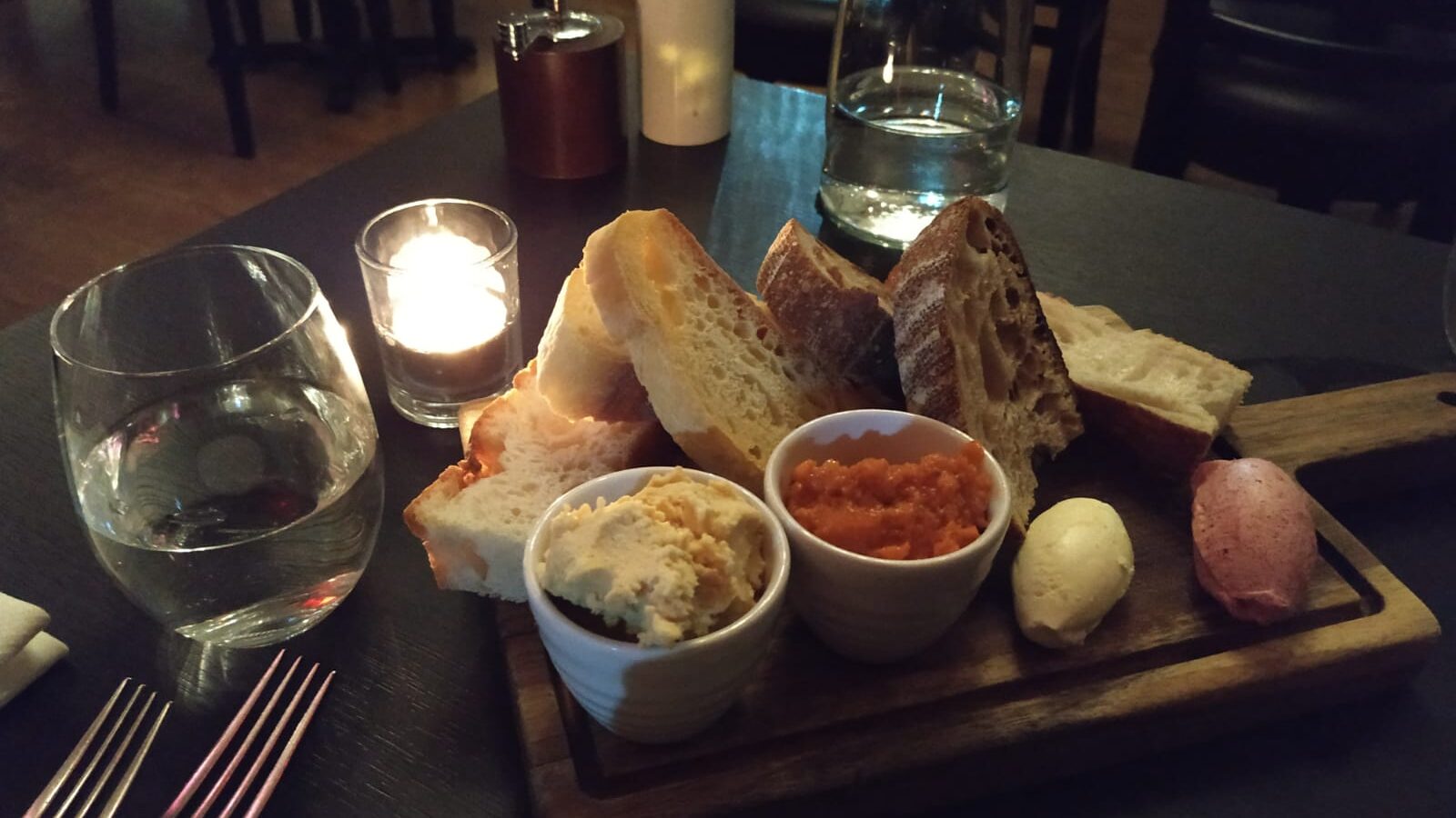 Platter of bread and spreads in Italian restaurant.