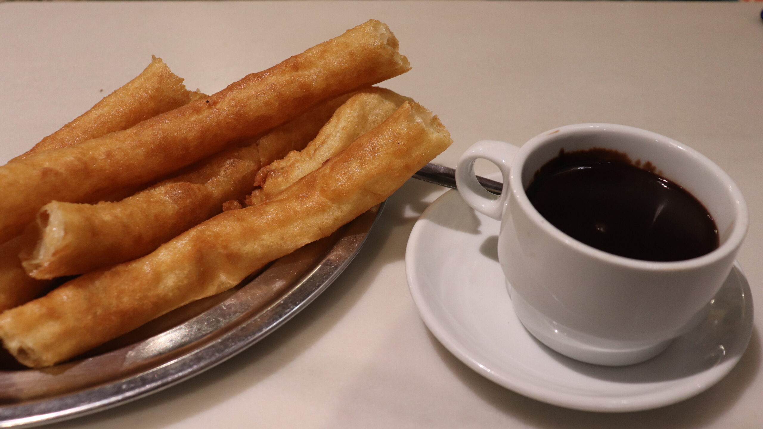 Thick churros with chocolate in Seville.