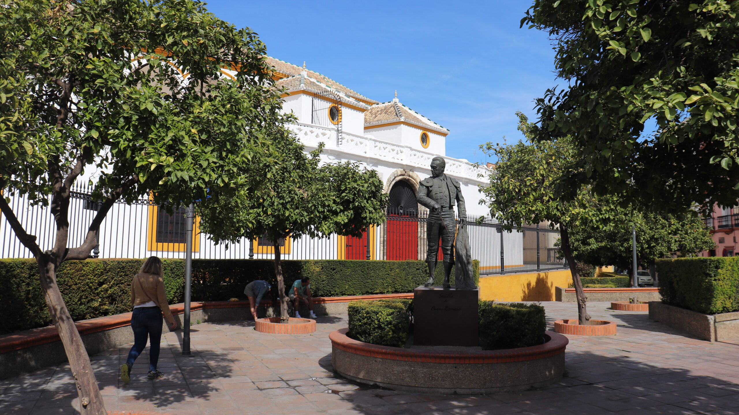 Exterior of bullring in Seville with statue outside.