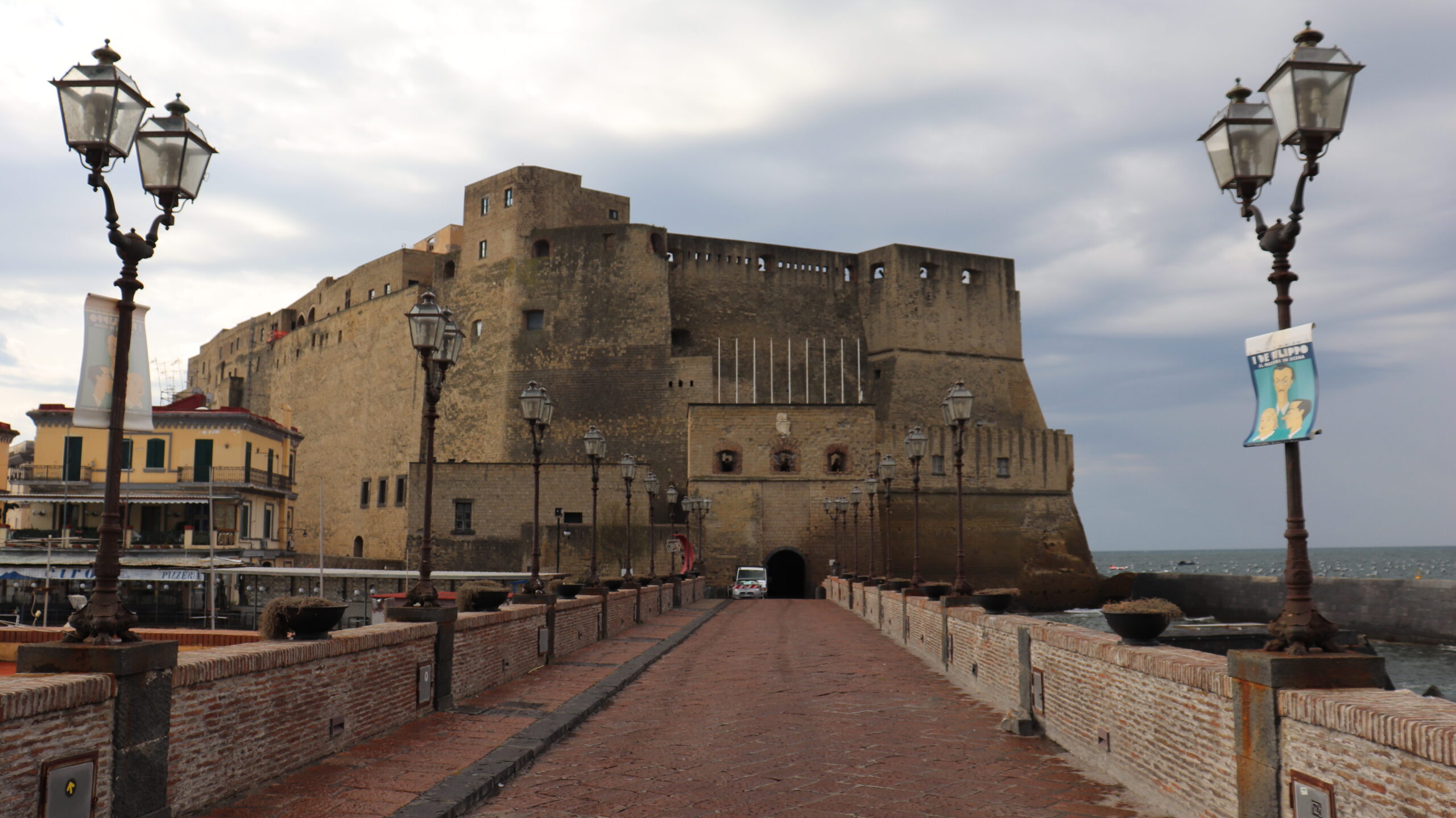 Large medieval castle along waterfront in Naples.