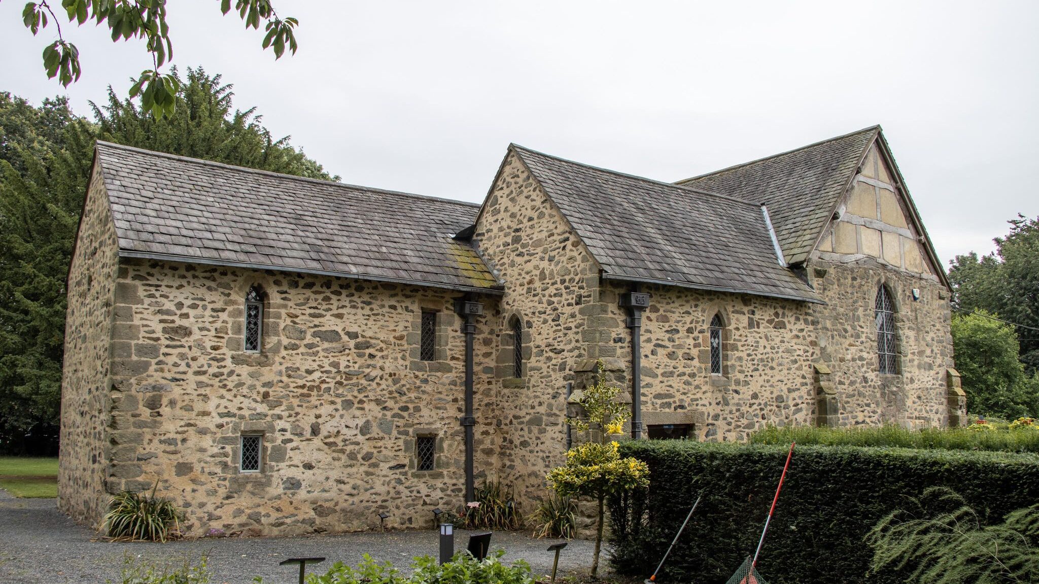 Exterior of stone house in countryside. 