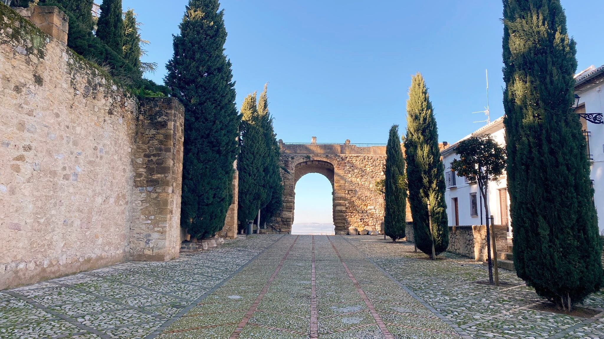 Stone arch next to castle.