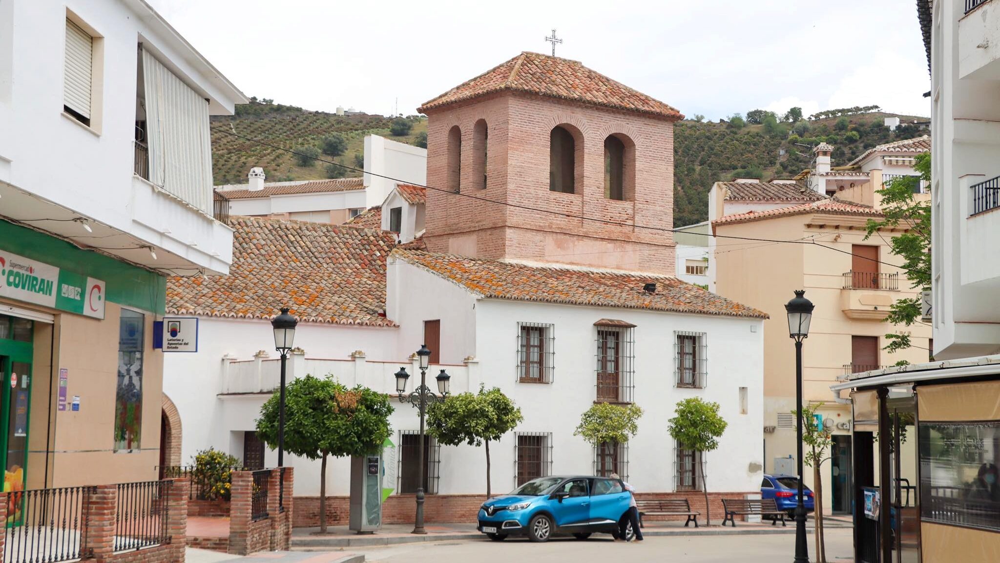 Brick building inside white village along the Ruta de la Pasa.