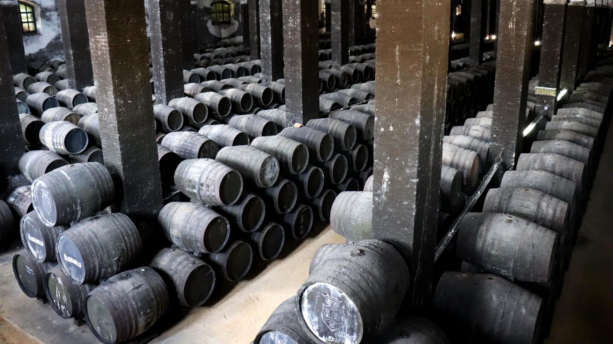 Stacks of wine barrels in bodega in Spain.