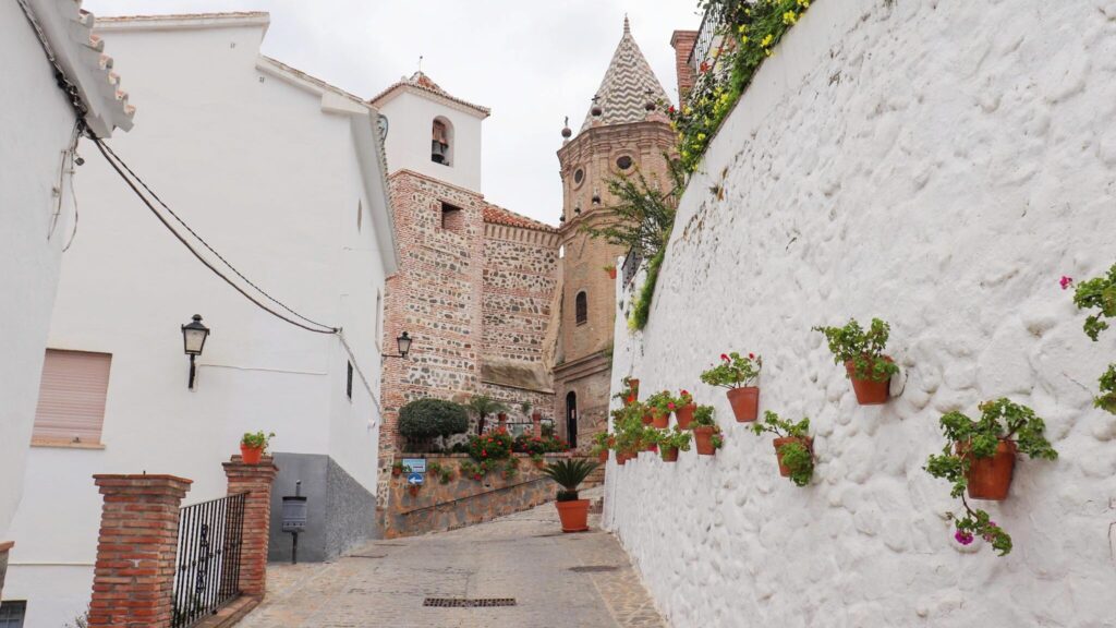 Whitewashed street with church at the end.