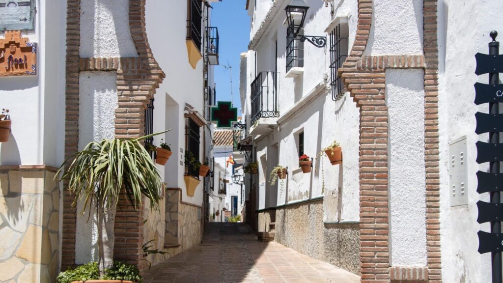 Whitewashed street in Comares with Arab arch.