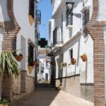 Whitewashed street in Comares with Arab arch.