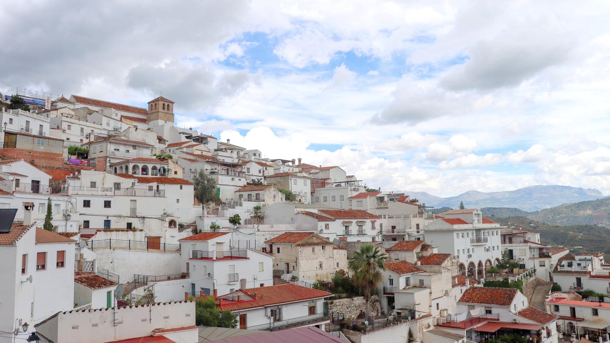 View of white village on cloudy day.