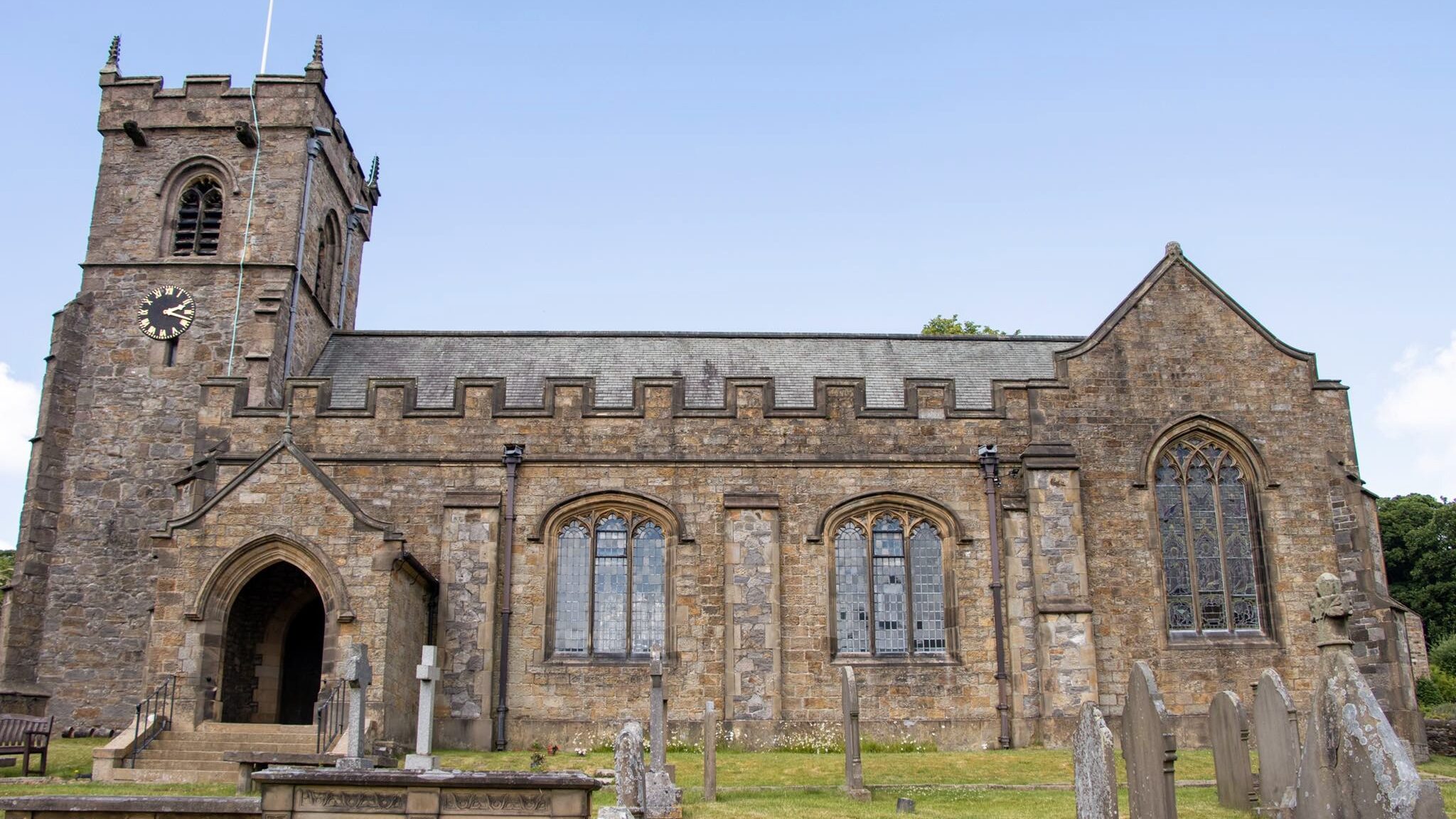 Medieval church with graveyard in front.