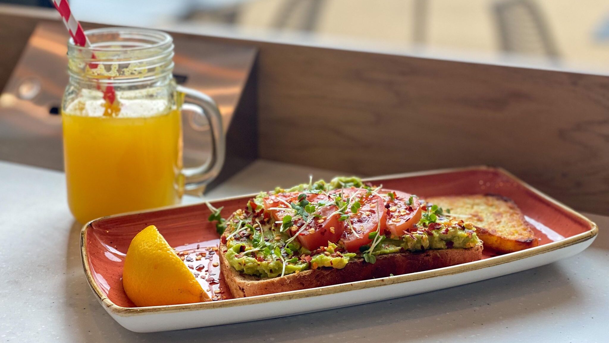 Avocado on toast with orange juice.