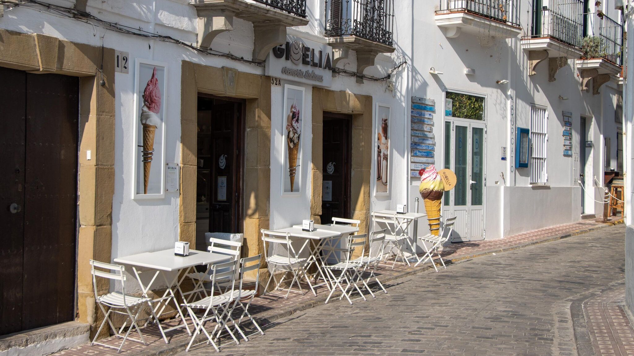 Outside an ice cream parlour with seating.