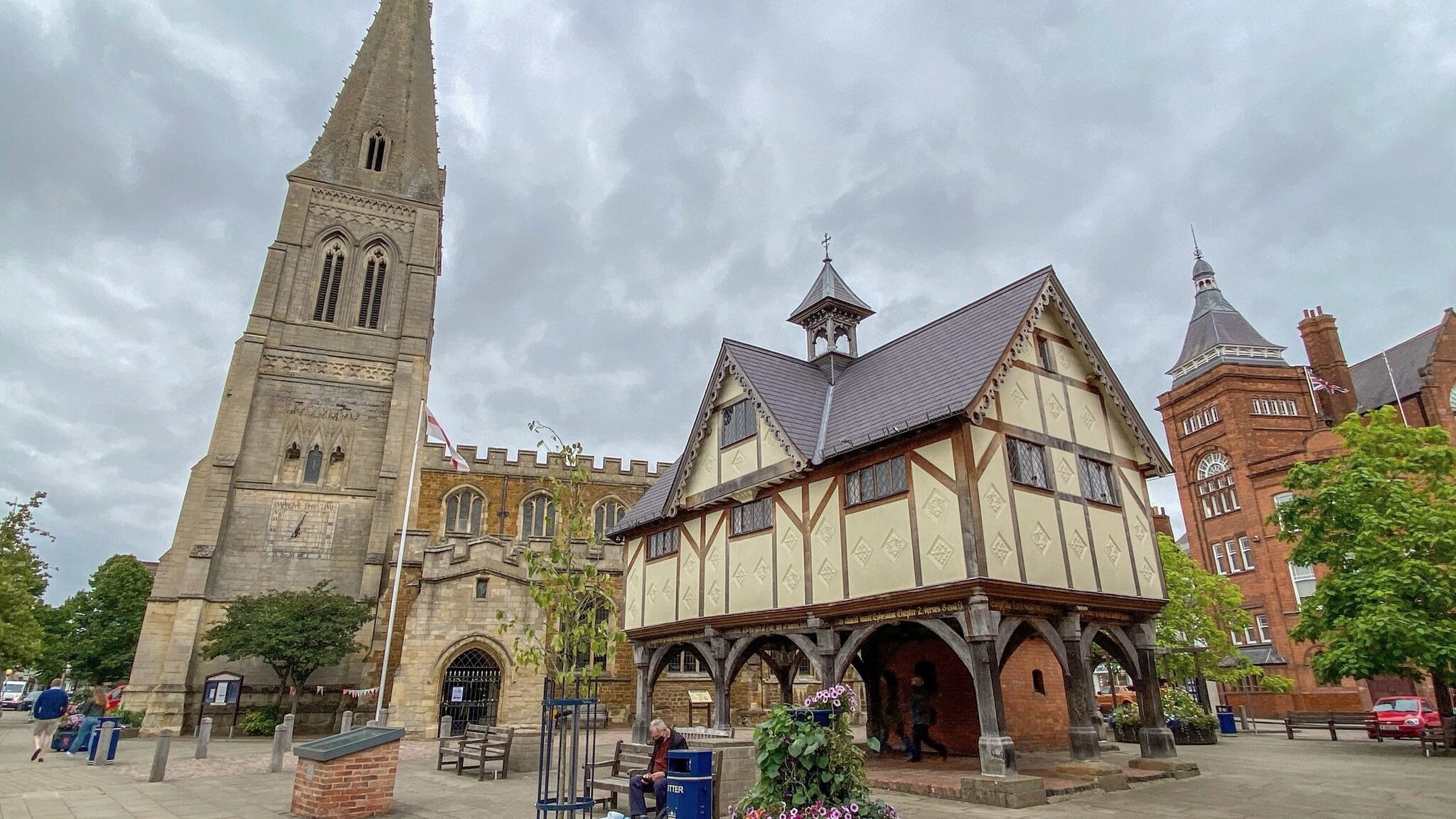 Medieval building and church in town square.