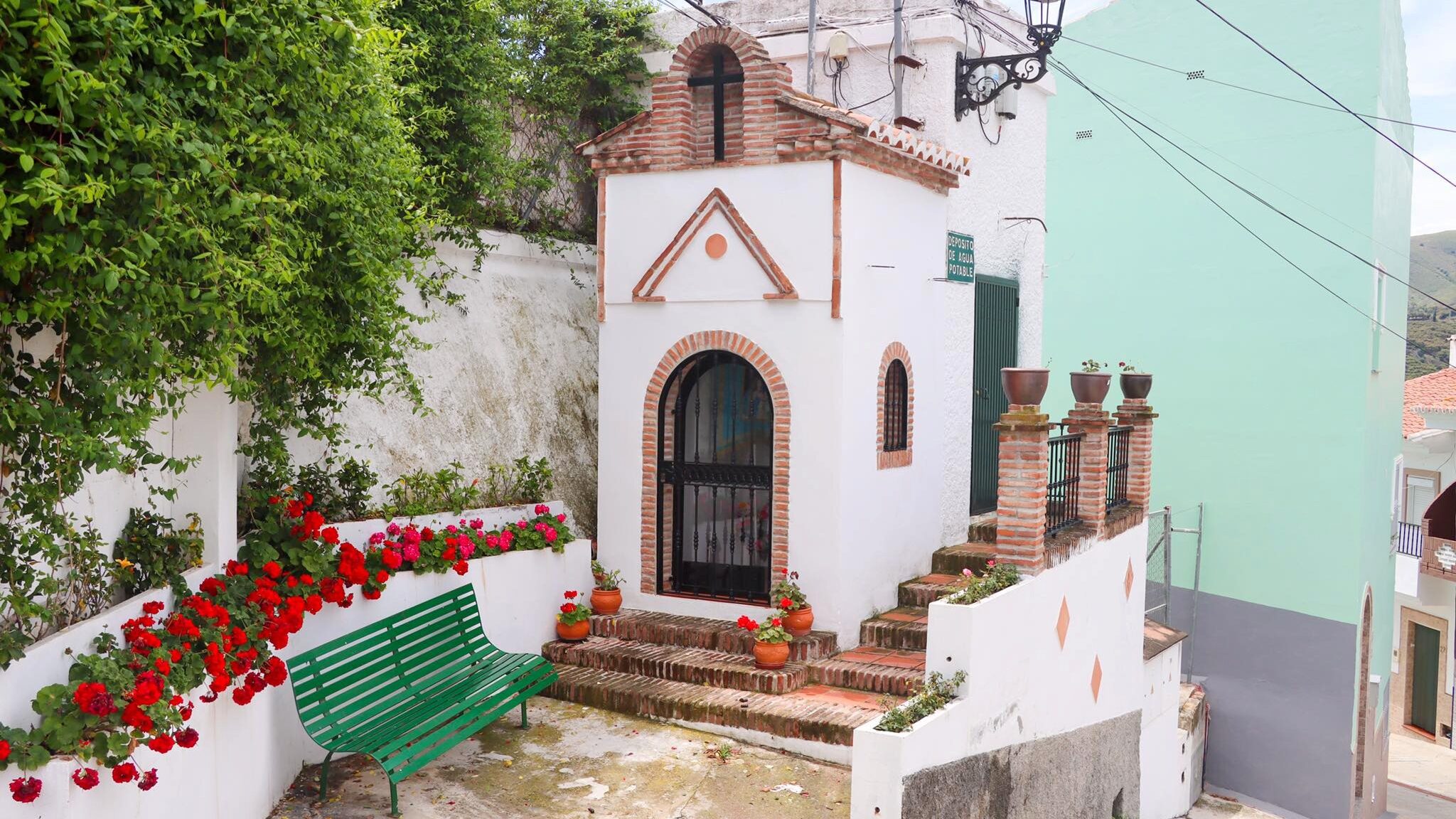 Small whitewashed hermitage in white village.