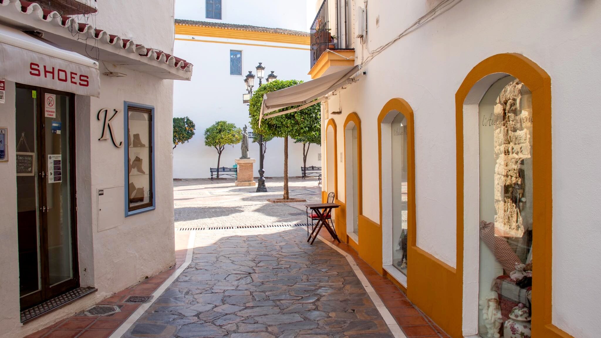 Street in Marbella's old town with shops.