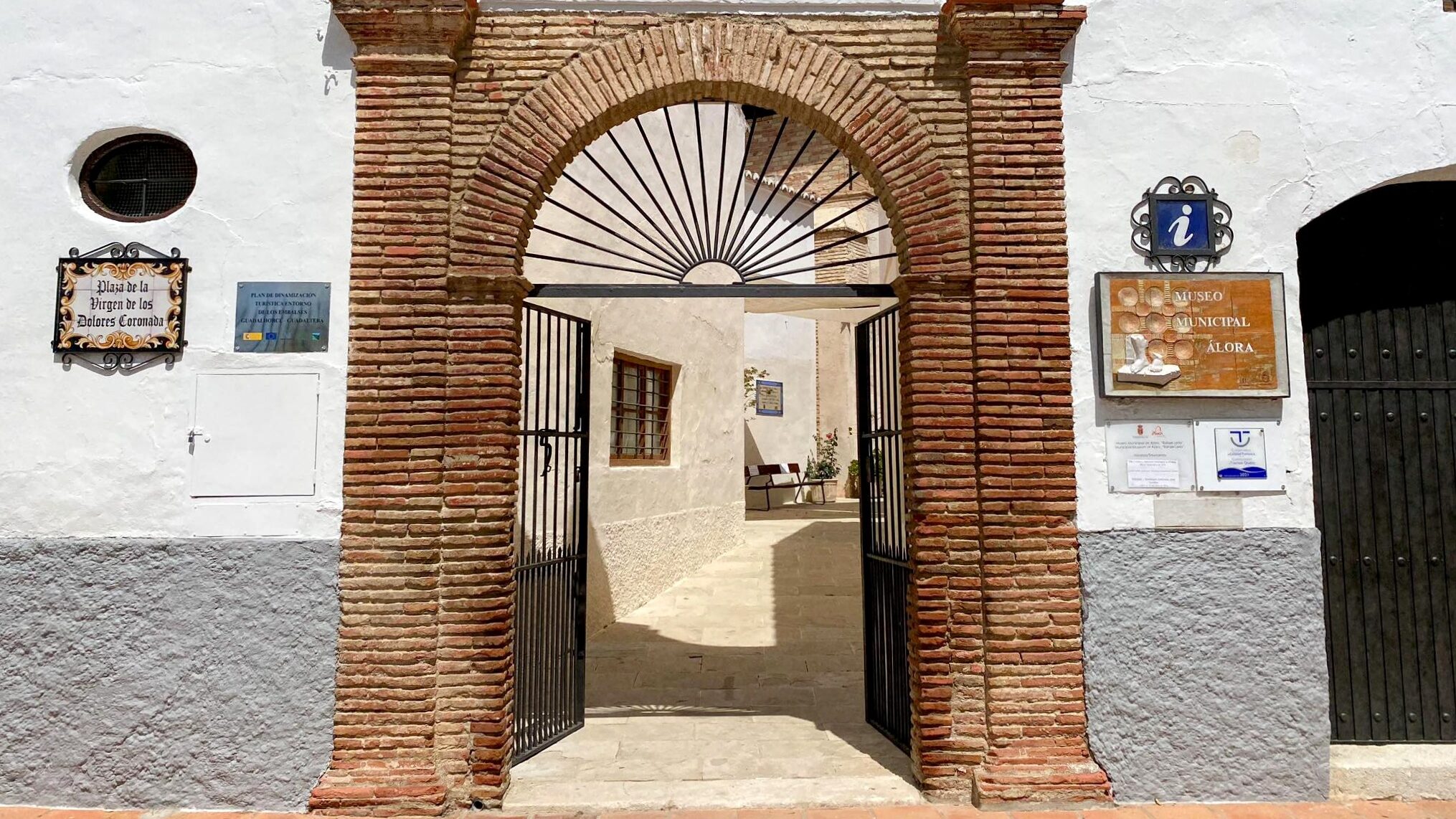 Brick arch entrance to museum in Alora.