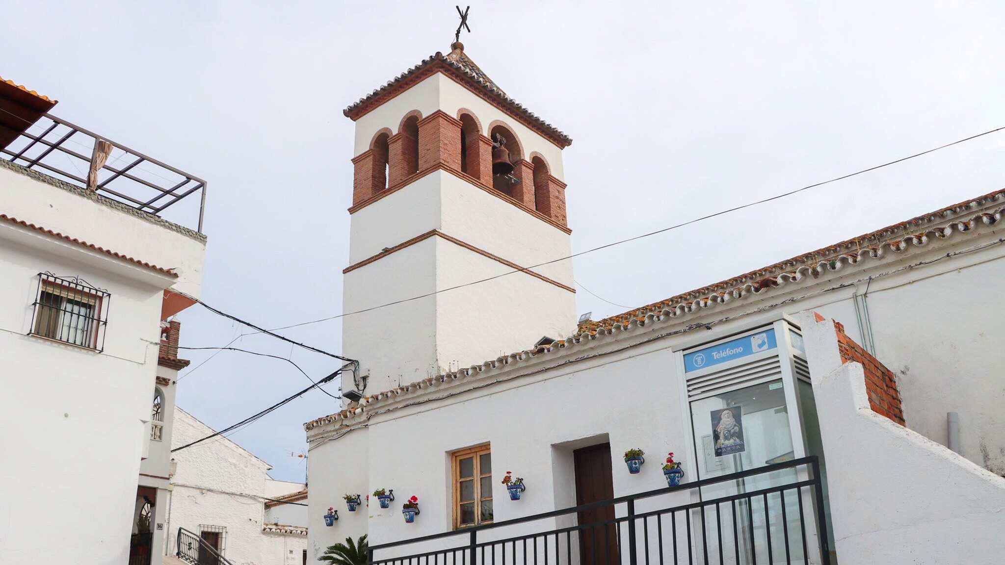 Small church with tower in white village.