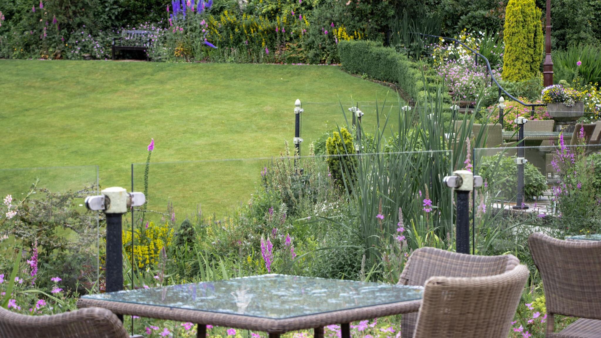 Outdoor seating area in garden of hotel.