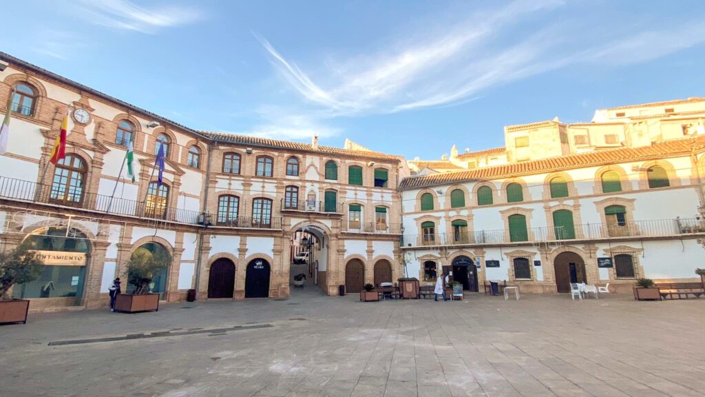 Large plaza in Archidona with shops.