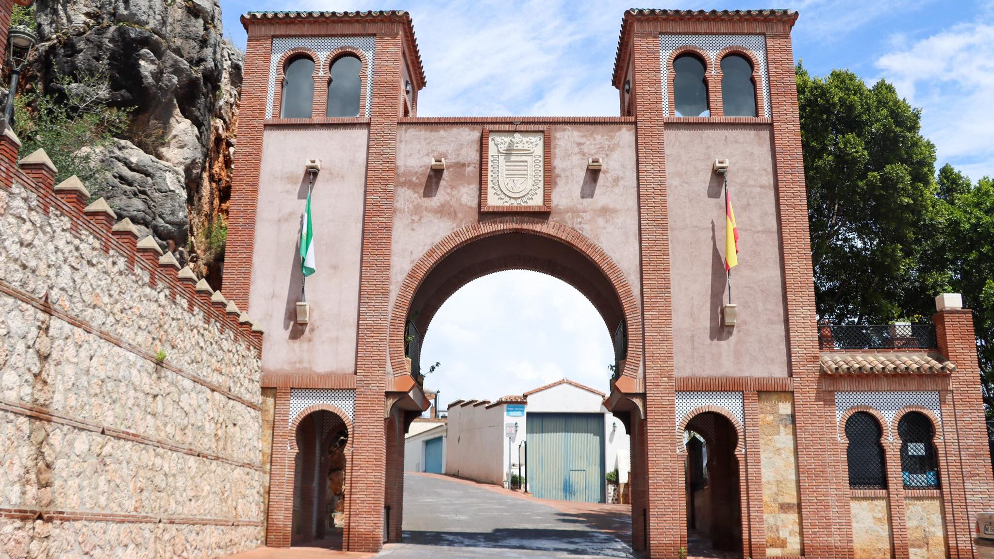 Large Arab arch entry to white village.