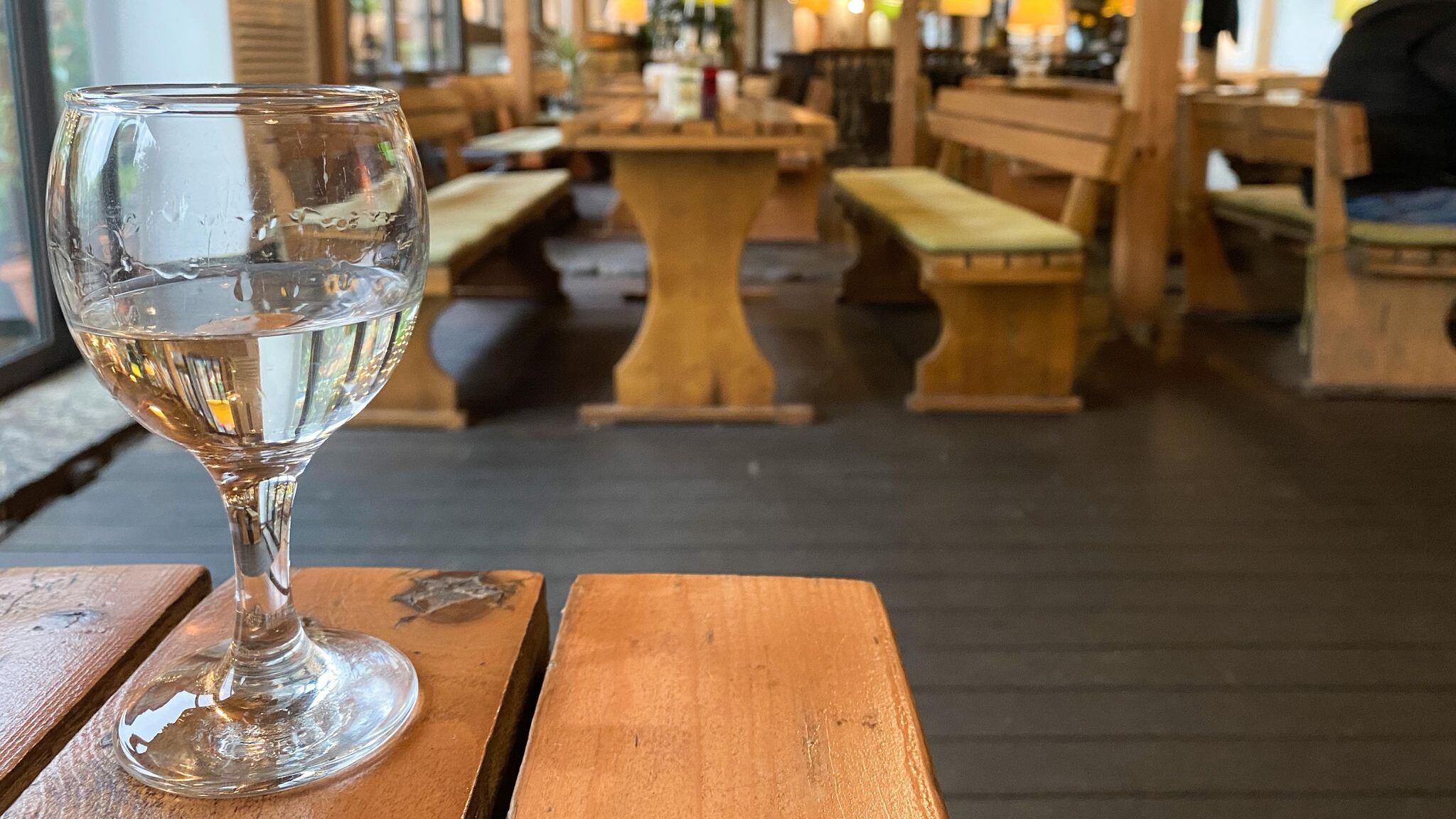 Clear spirit in glass on table.