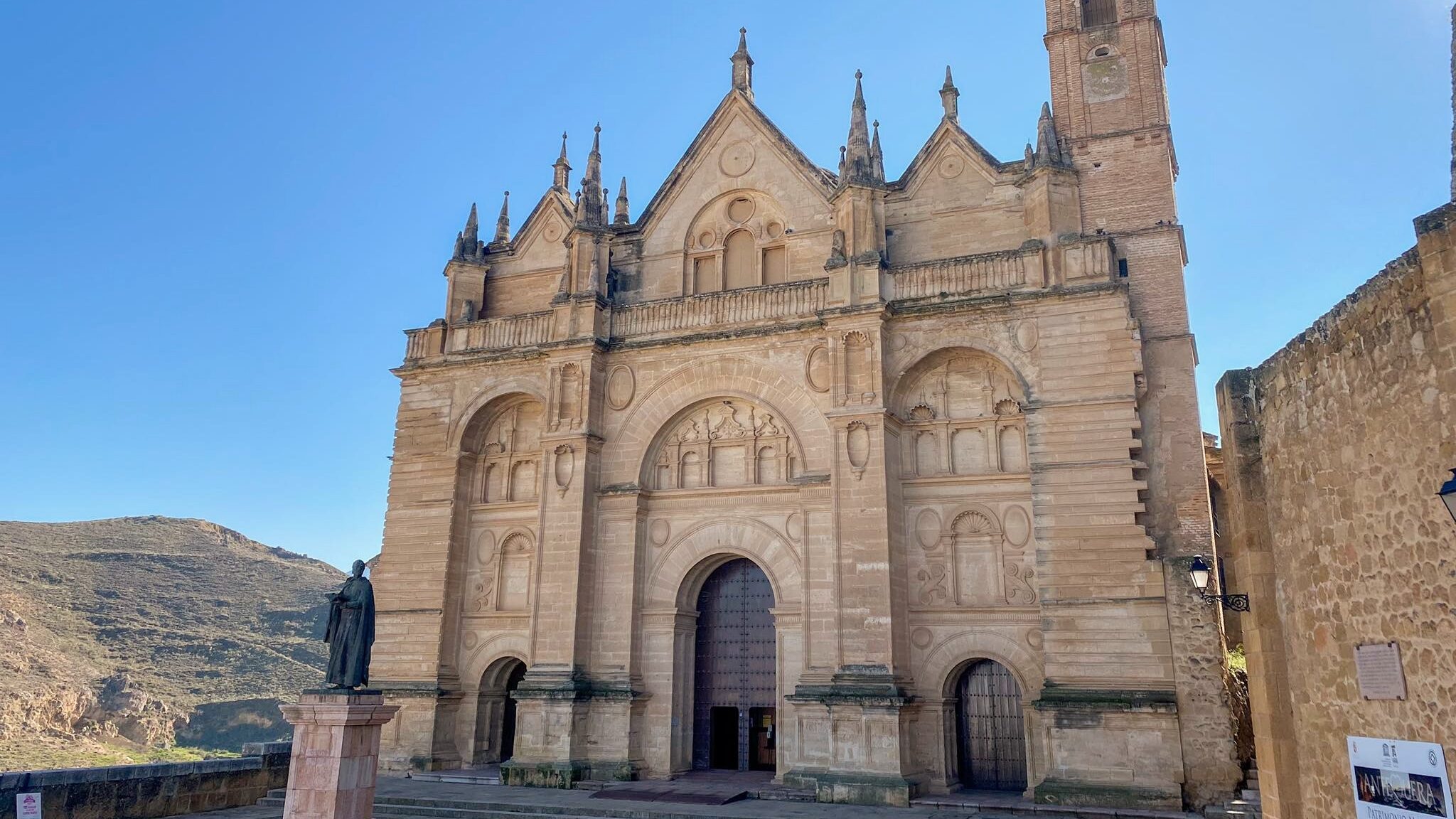 Large stone church in small plaza.