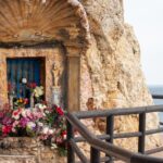 Small prayer hermitage in rocks along coastal walk.