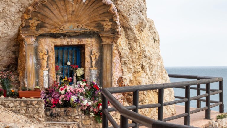 Small prayer hermitage in rocks along coastal walk.