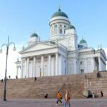 White cathedral in large square in Helsinki.