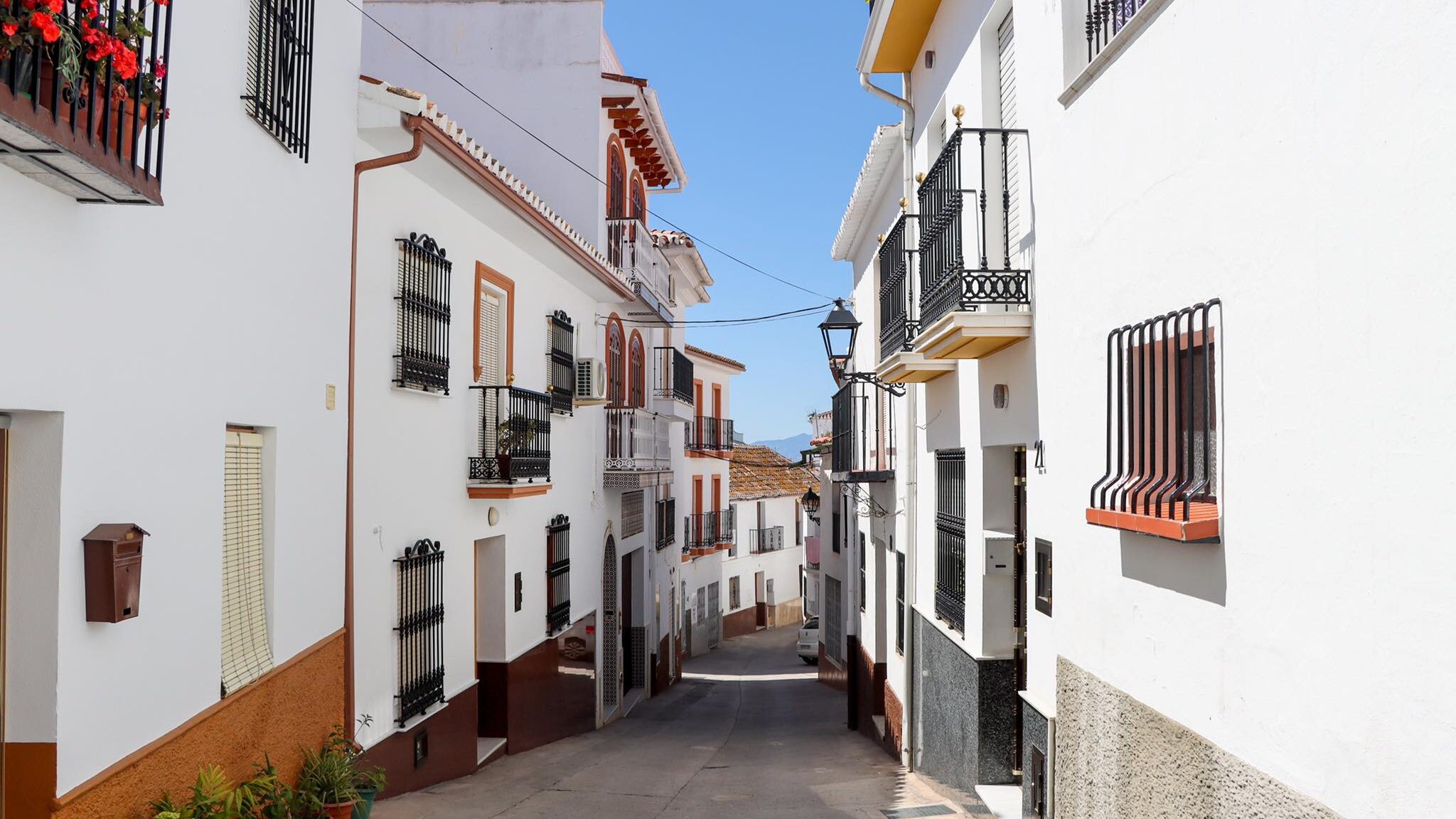 Narrow whitewashed street in Spanish village.