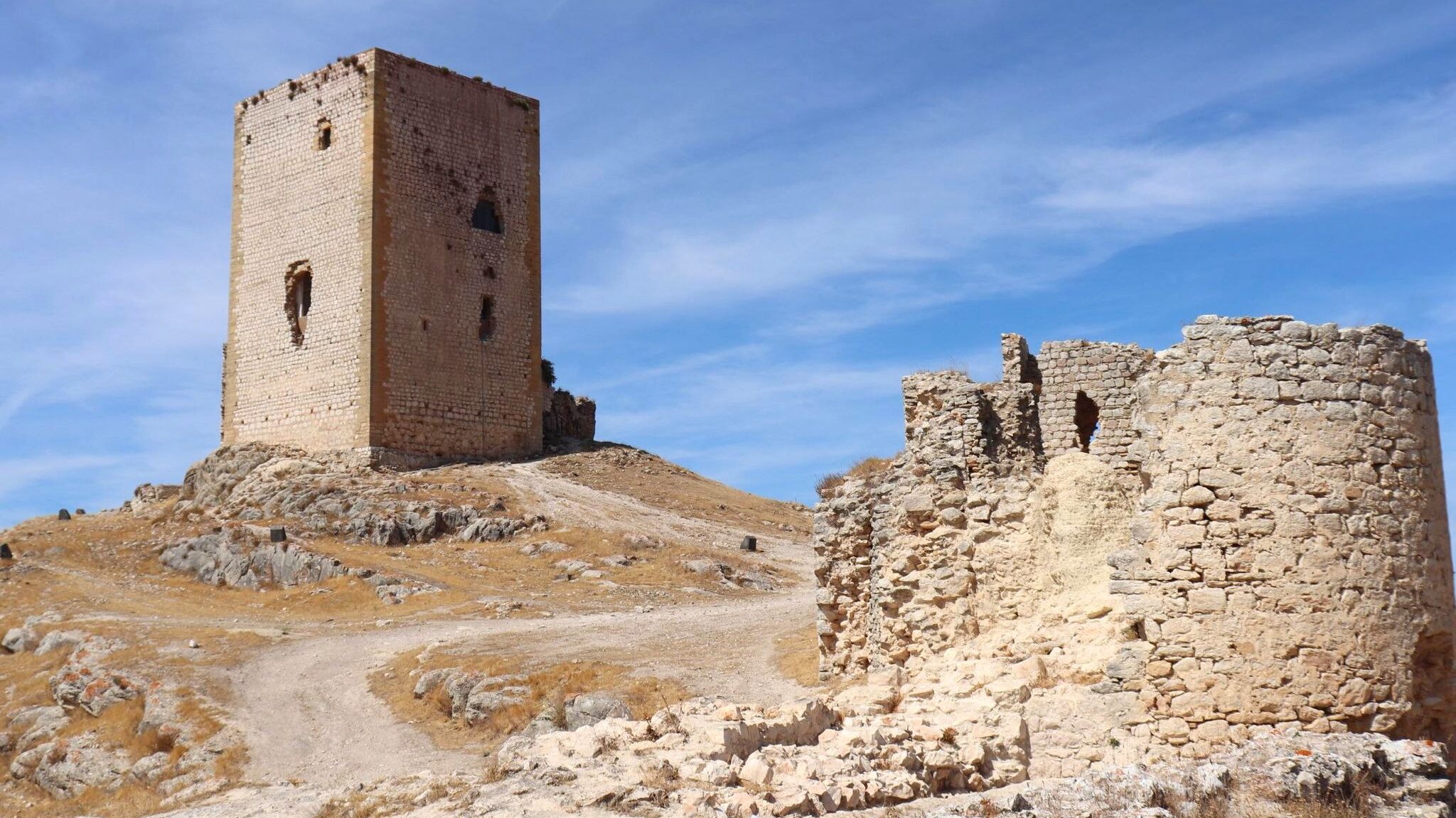 Medieval castle tower on hillside in Malaga.