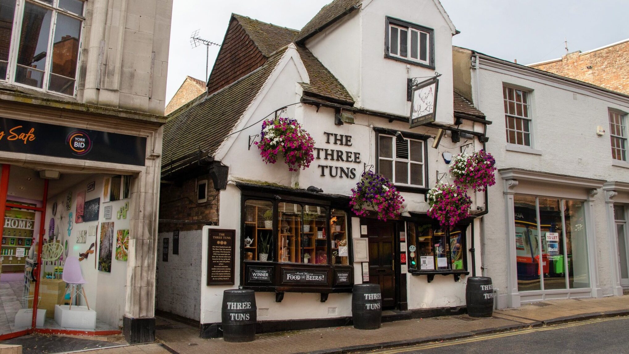 Medieval pub with flowers out front.