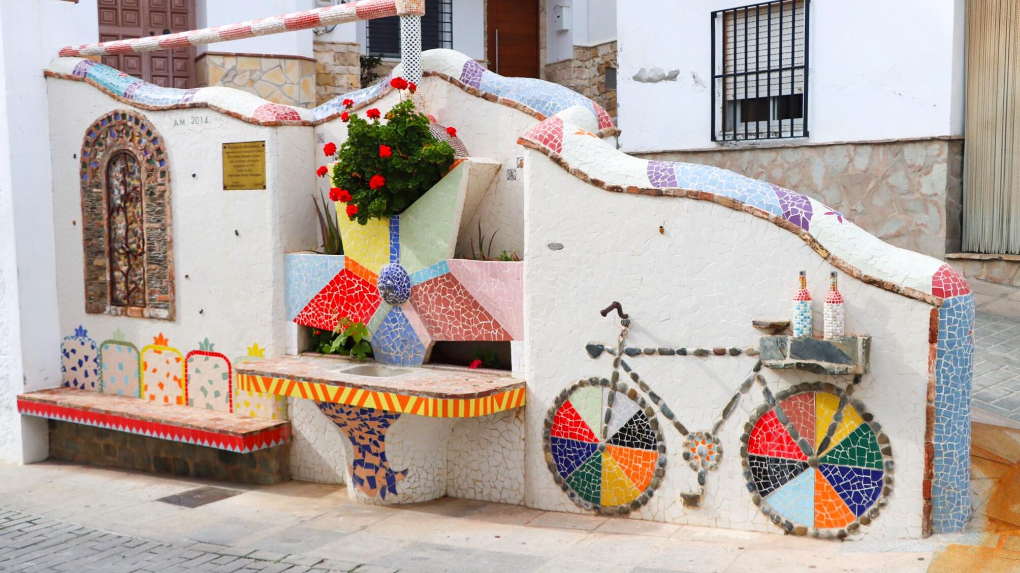 White wall with mosaics on it.