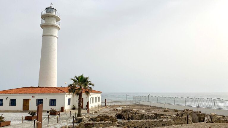 Lighthouse sitting next to beach in Torrox.