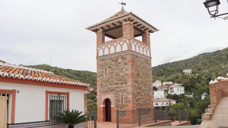 Small brick tower in white village.