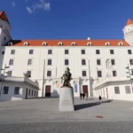 Large white castle on hill during a day in Bratislava.