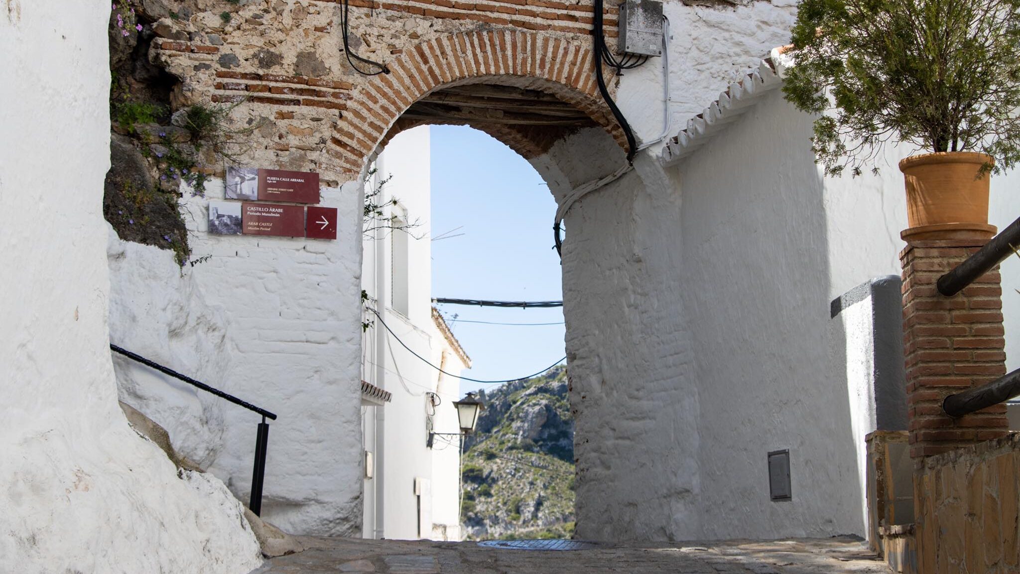 Old Arab arch in white village.