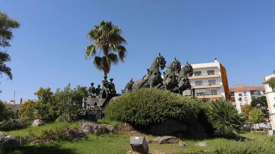 Statue of man on horse carriage.