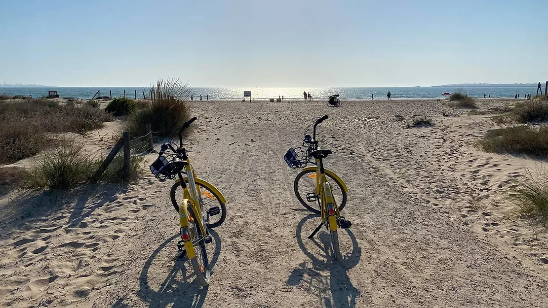 Two bikes next to beach in Jerez.