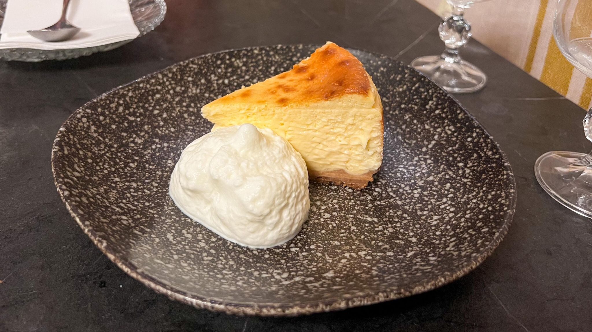 Basque cheesecake with side of cream.