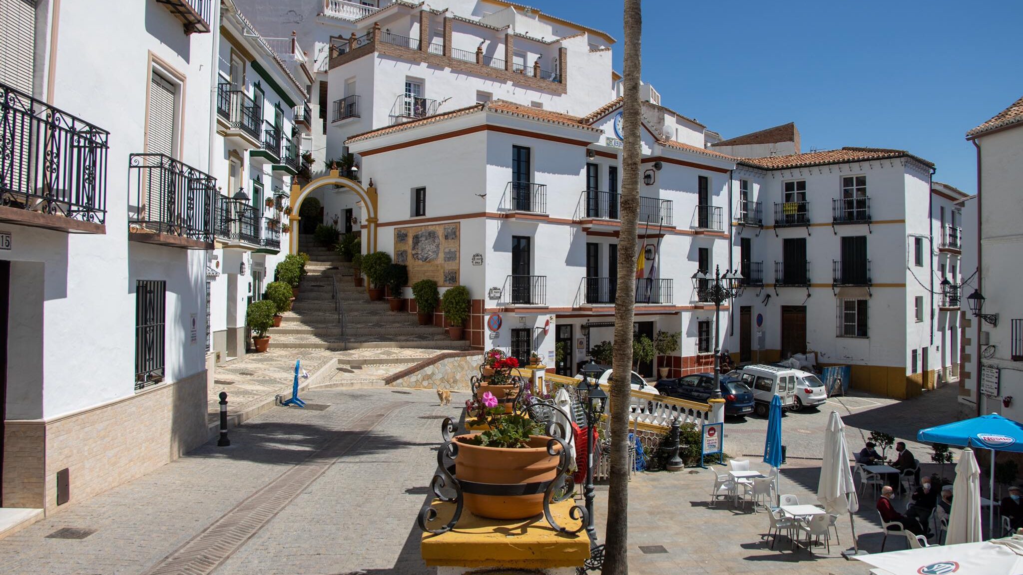 Small plaza surrounded by white houses.