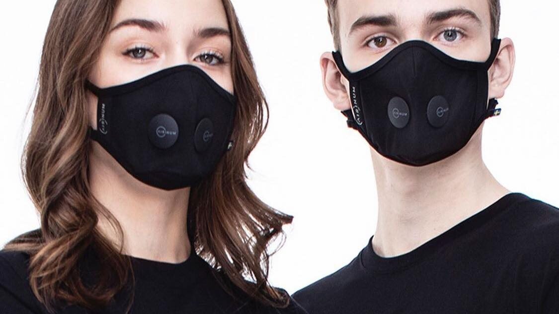 Two people wearing black face masks.