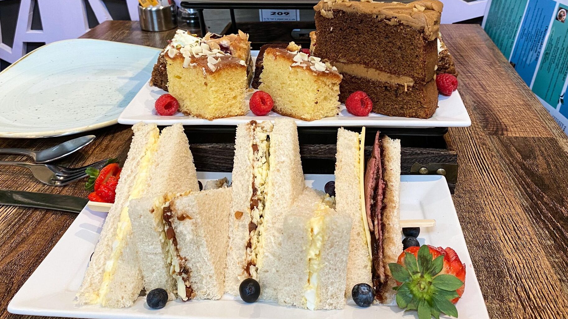 Row of sandwiches on afternoon tea stand.