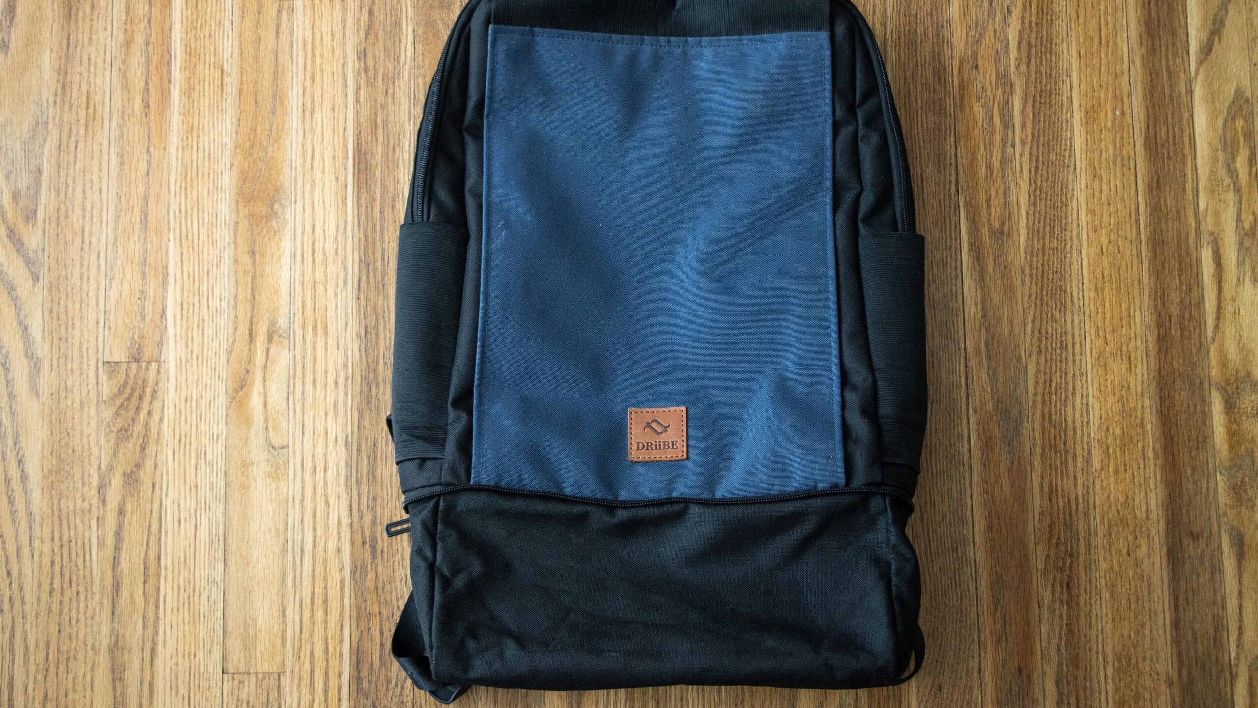 Blue and black DRiiBE CITYC Urban Backpack on floor.