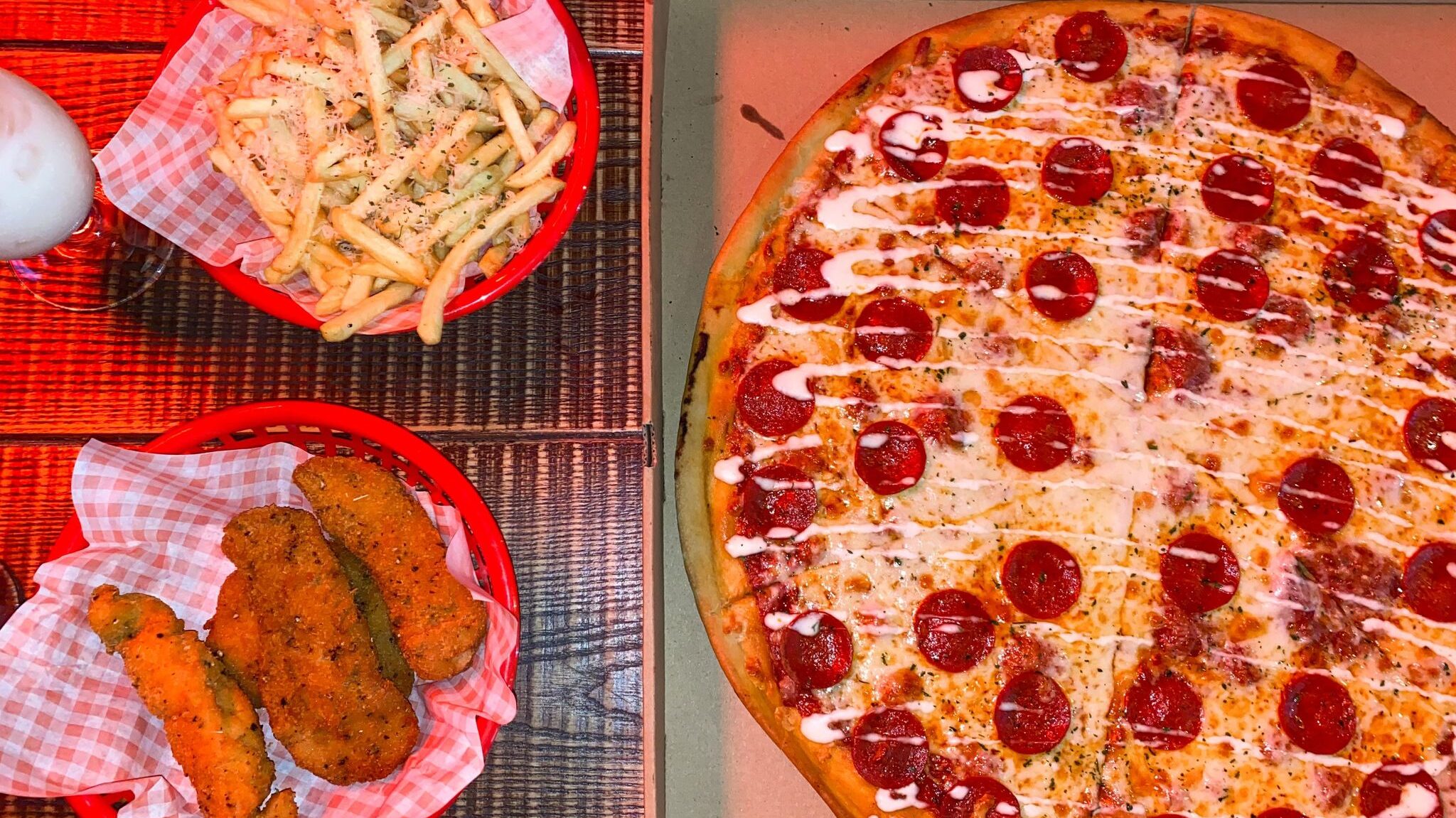 Pepperoni pizza and side of fries and chicken.